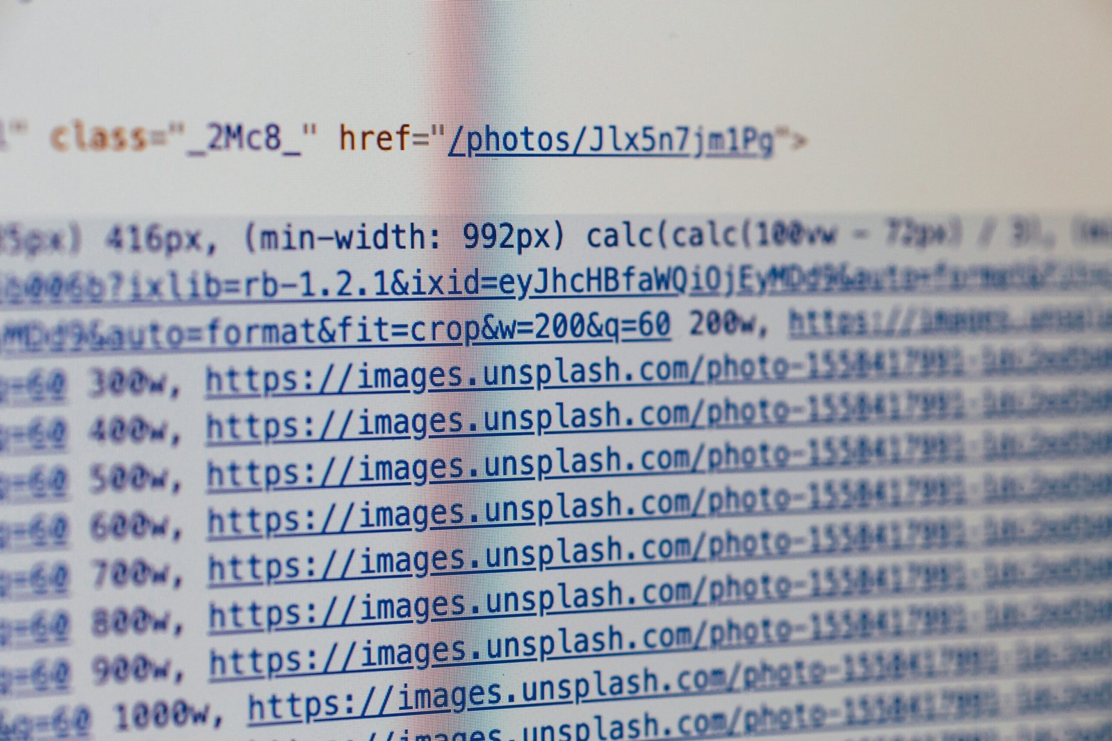 Computer screen showing HTML code editor with alt text attribute highlighted in yellow, demonstrating how to add alternative text to images in web development