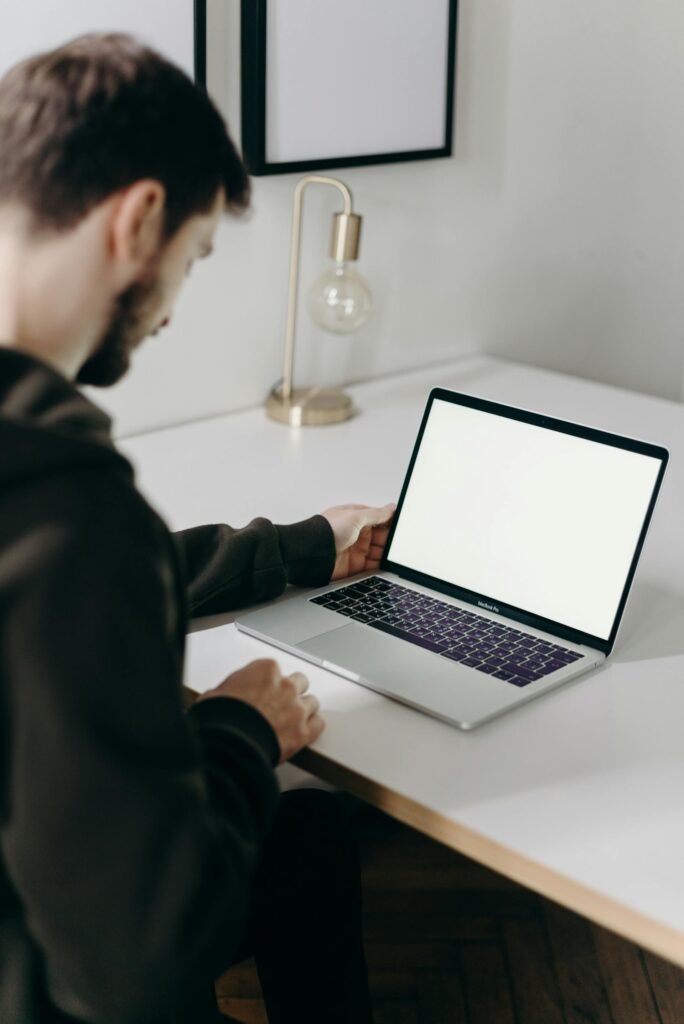 Person using assistive technology with headphones and keyboard to navigate a website, demonstrating how screen readers use alt text for web accessibility